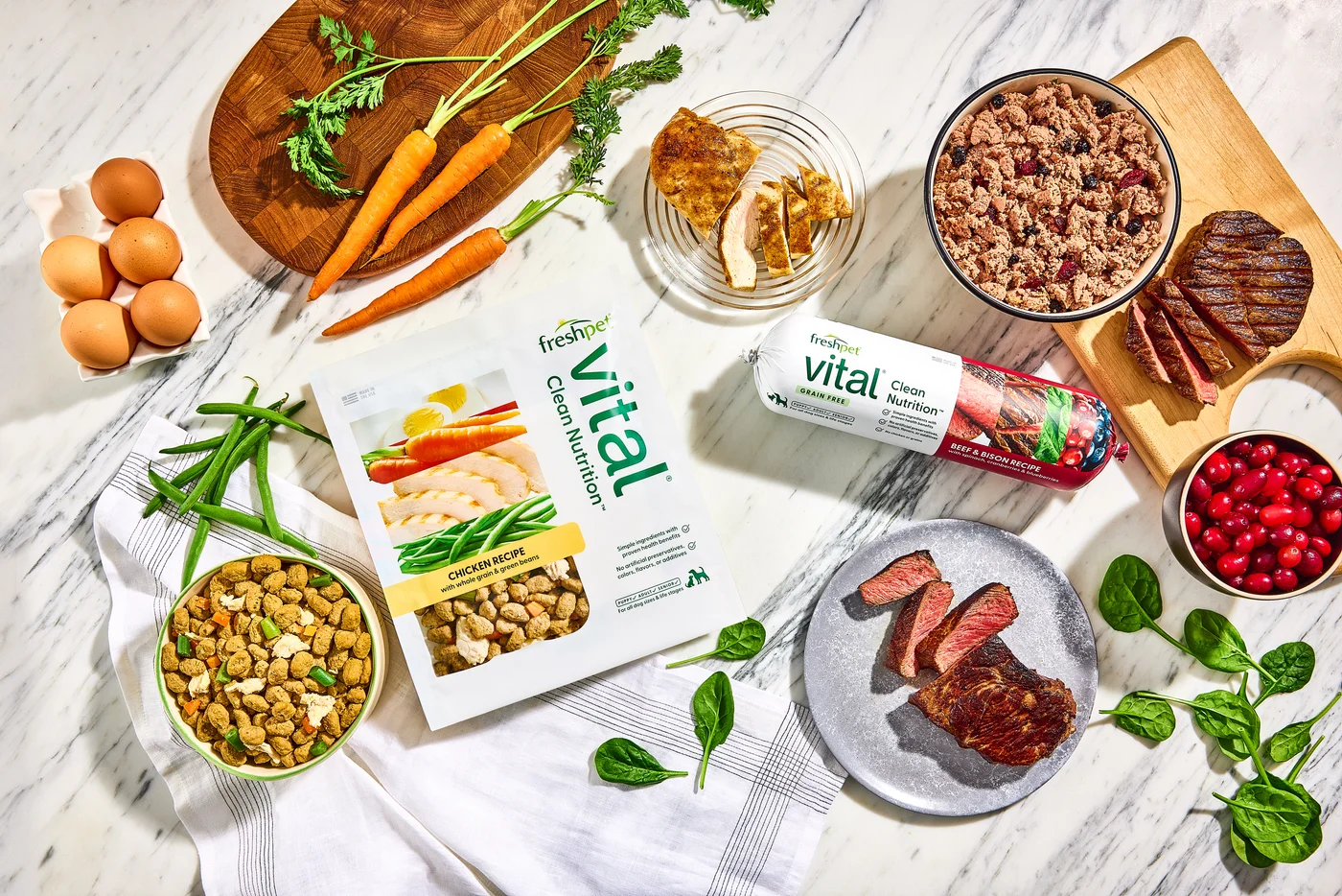 Freshpet Vital recipes displayed with their real ingredients: chicken, beef, bison, eggs, green beans, spinach, and cranberries